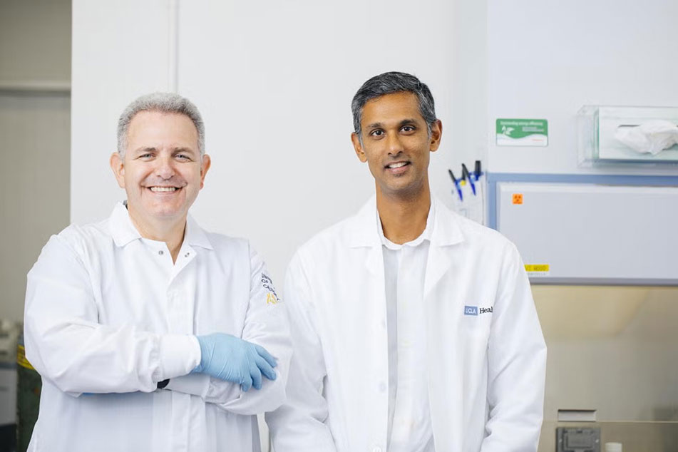 Bennett Novitch and Dr. Ranmal Samarasinghe wearing white lab coats